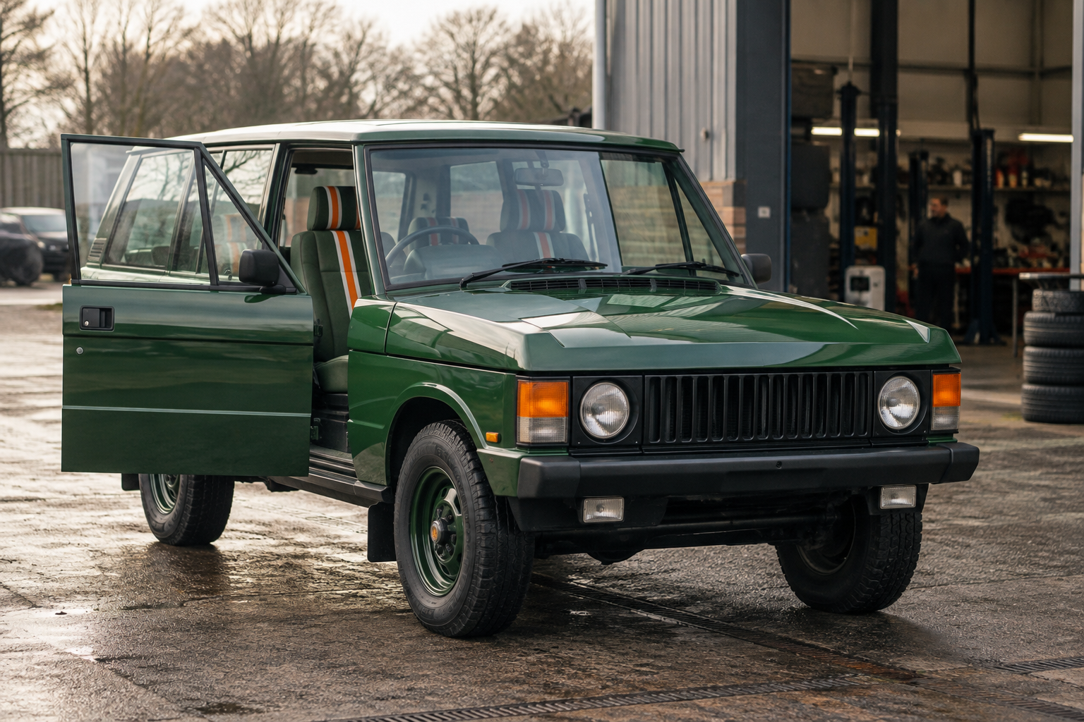 Late-20th-century Range Rover Classic in vivid green, with its door open at Lunaz’s Silverstone restomod workshop.